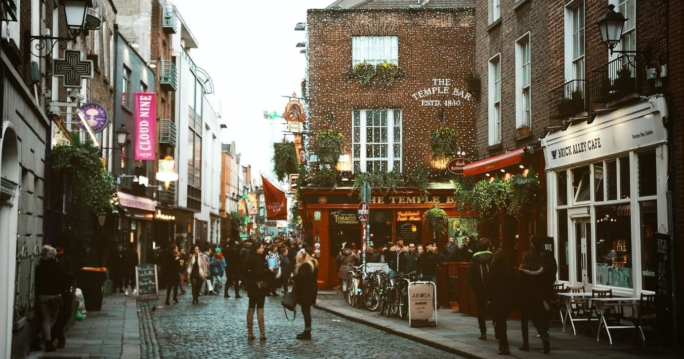 Cobblestone city walking tour through lively pedestrian street