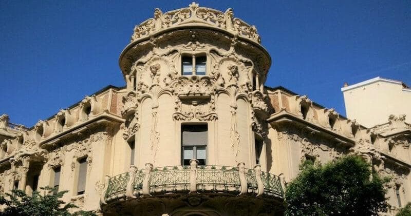Historic ornate city building facade under clear blue sky