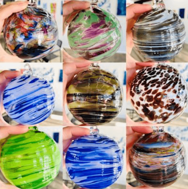 Colorful blown glass bowls displayed on table in studio