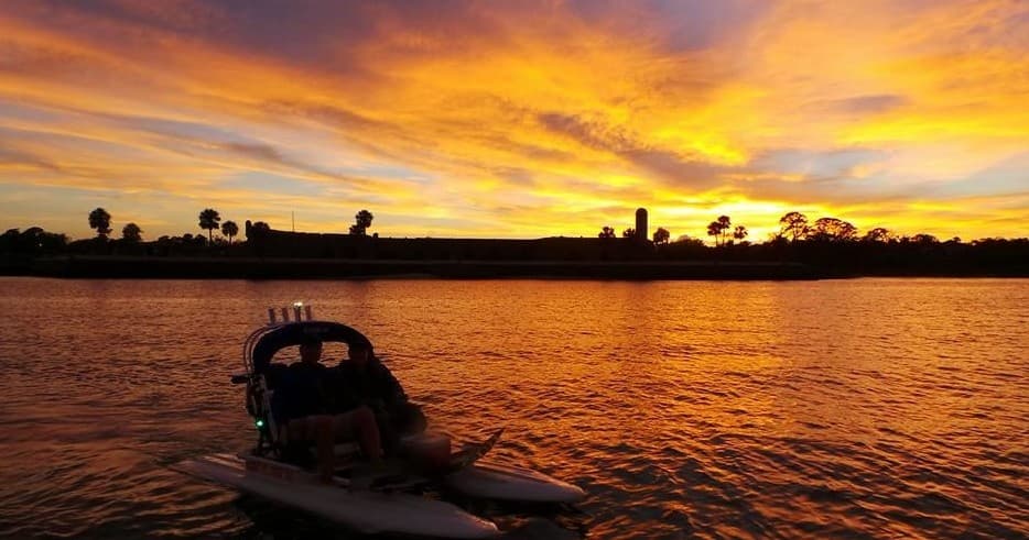 Sunset boat silhouette on St Augustine inlet during coastal tour