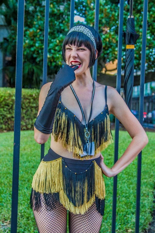 Costumed performer posing in park during city walking tour