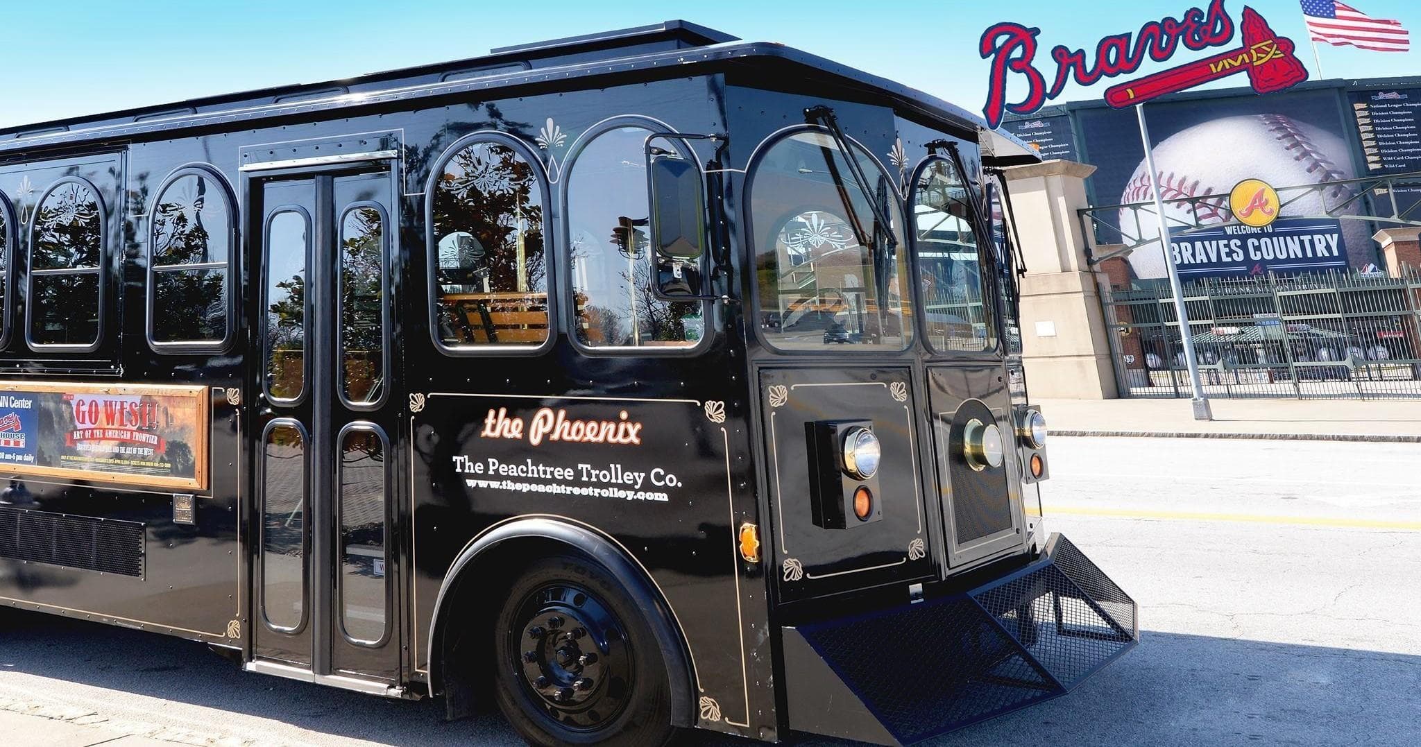 Black trolley in front of Braves stadium offering guided city tours