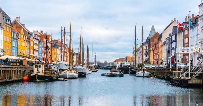 Colorful canal boat tour in Nyhavn Copenhagen harbor