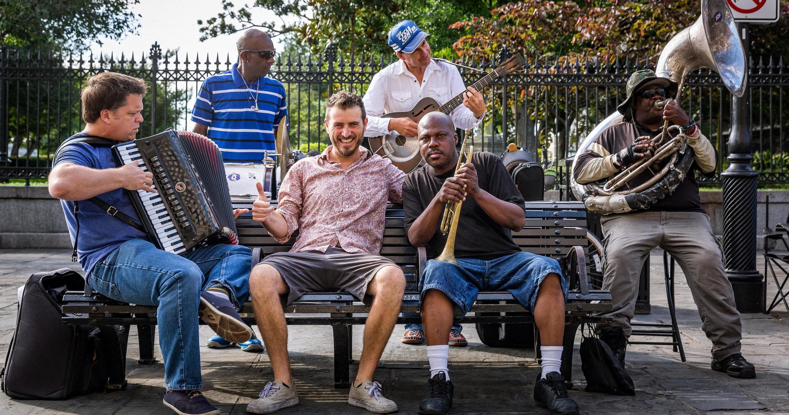 Outdoor brass and accordion band performing jazz in city park