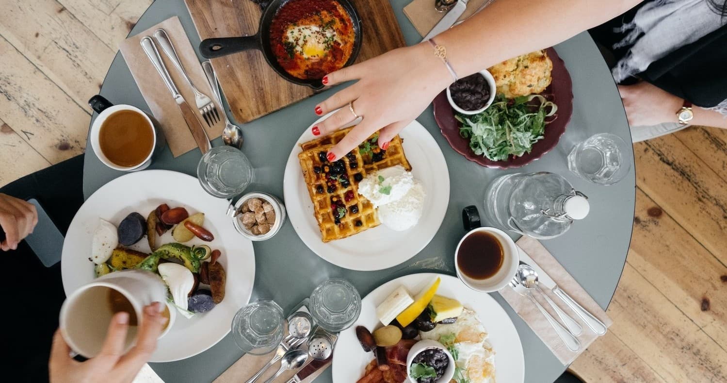 Group enjoying brunch at a cafe table during Portland food tour