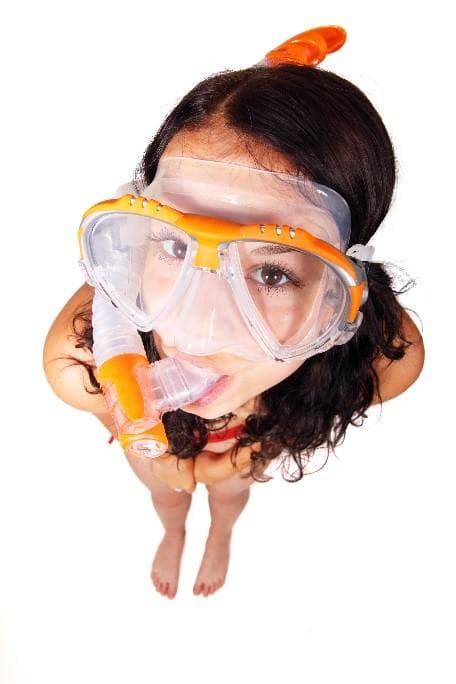 Person wearing snorkel mask portrait on white background, studio