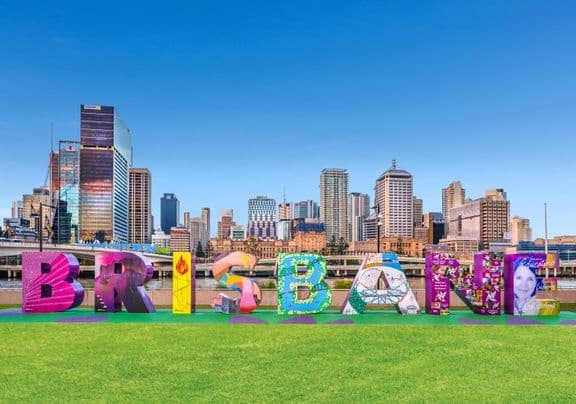 Brisbane city sign with skyline panorama in sunny park setting