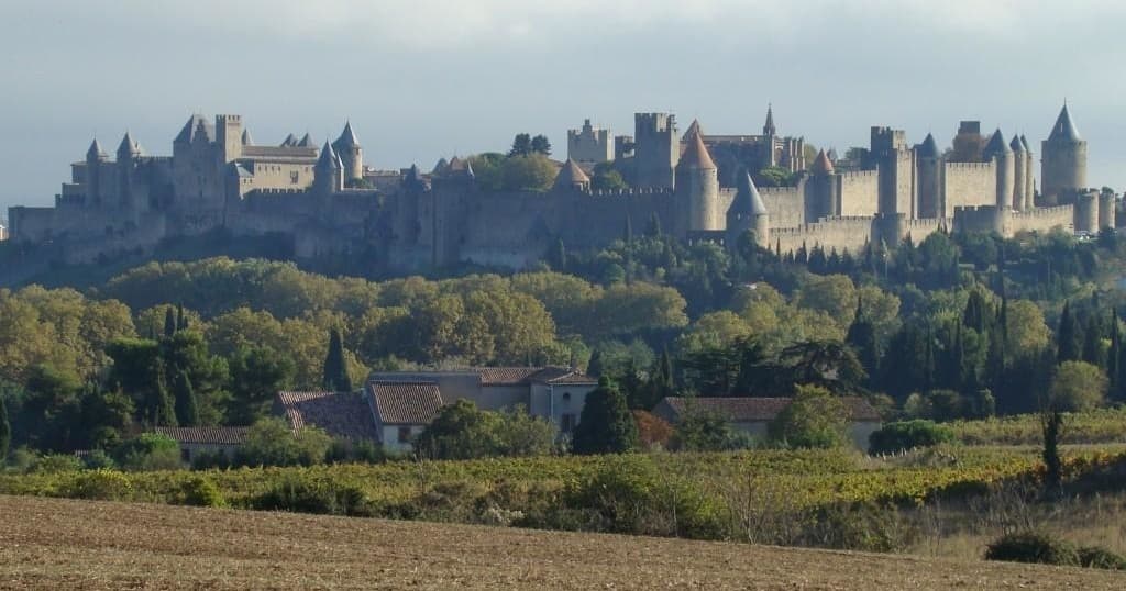 Panoramic medieval Carcassonne fortress vista over fields