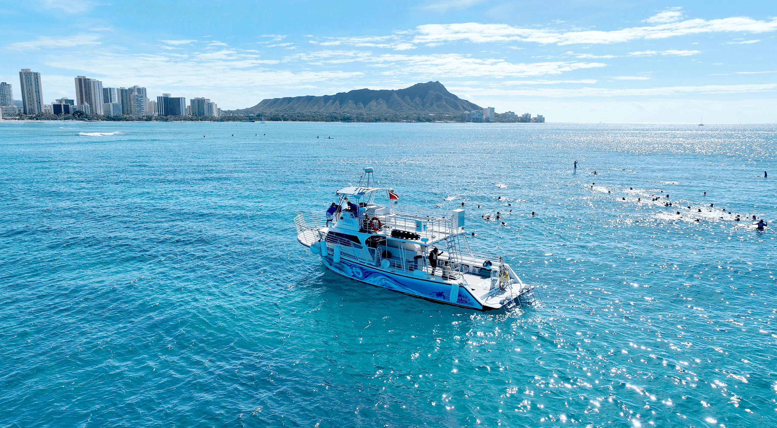 Tour boat cruising near Diamond Head and Waikiki coastline