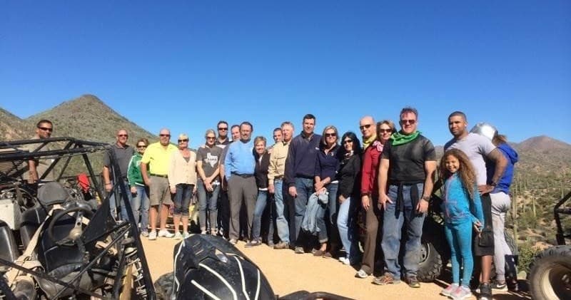 Group of off-road riders with UTVs on a desert scenic tour