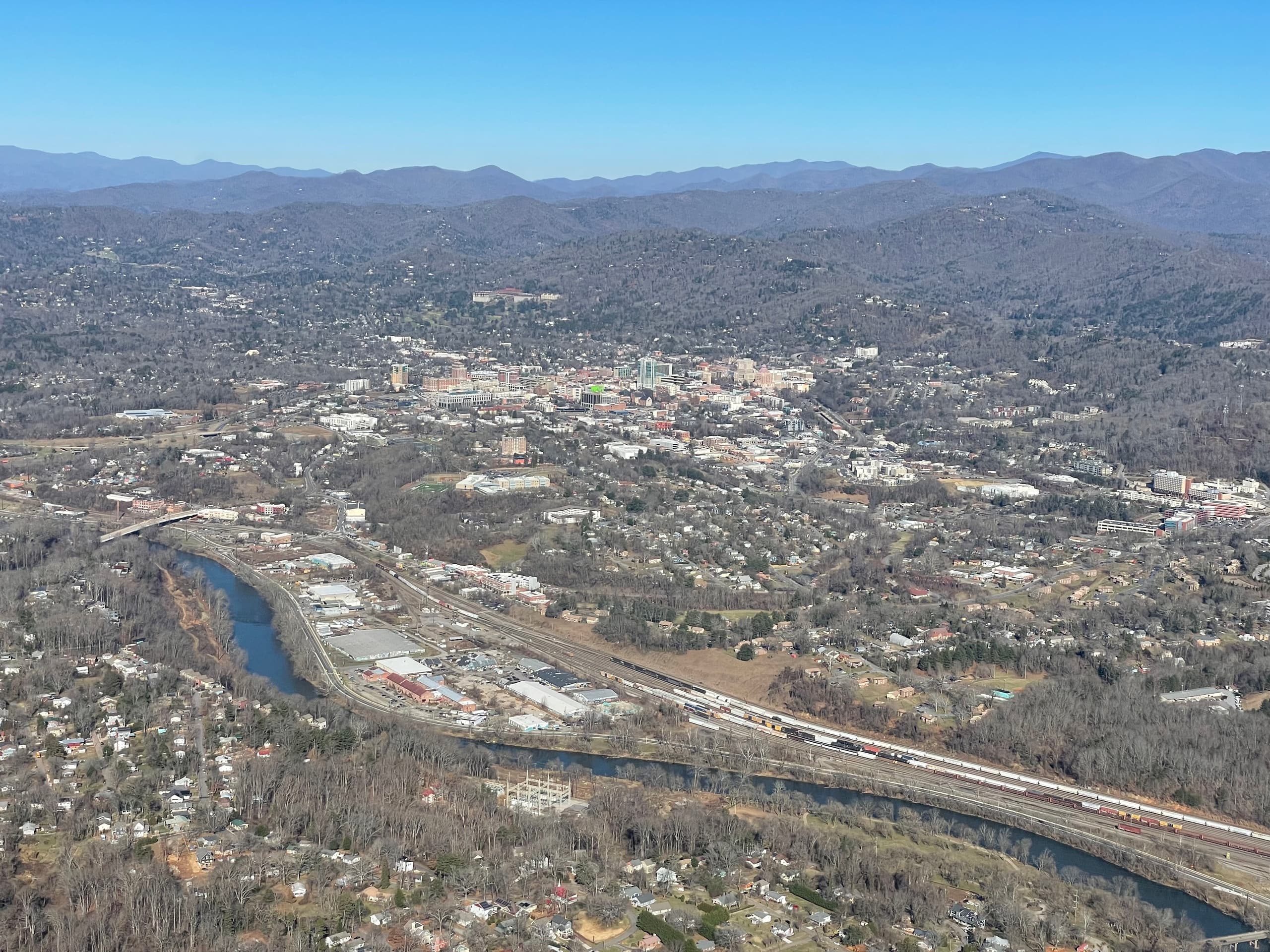 Helicopter aerial over winding river and sandbar coastal landscape