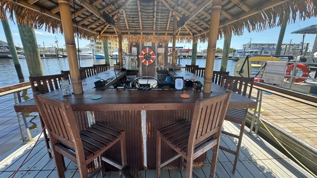 Thatched tiki bar seating on floating dock with view