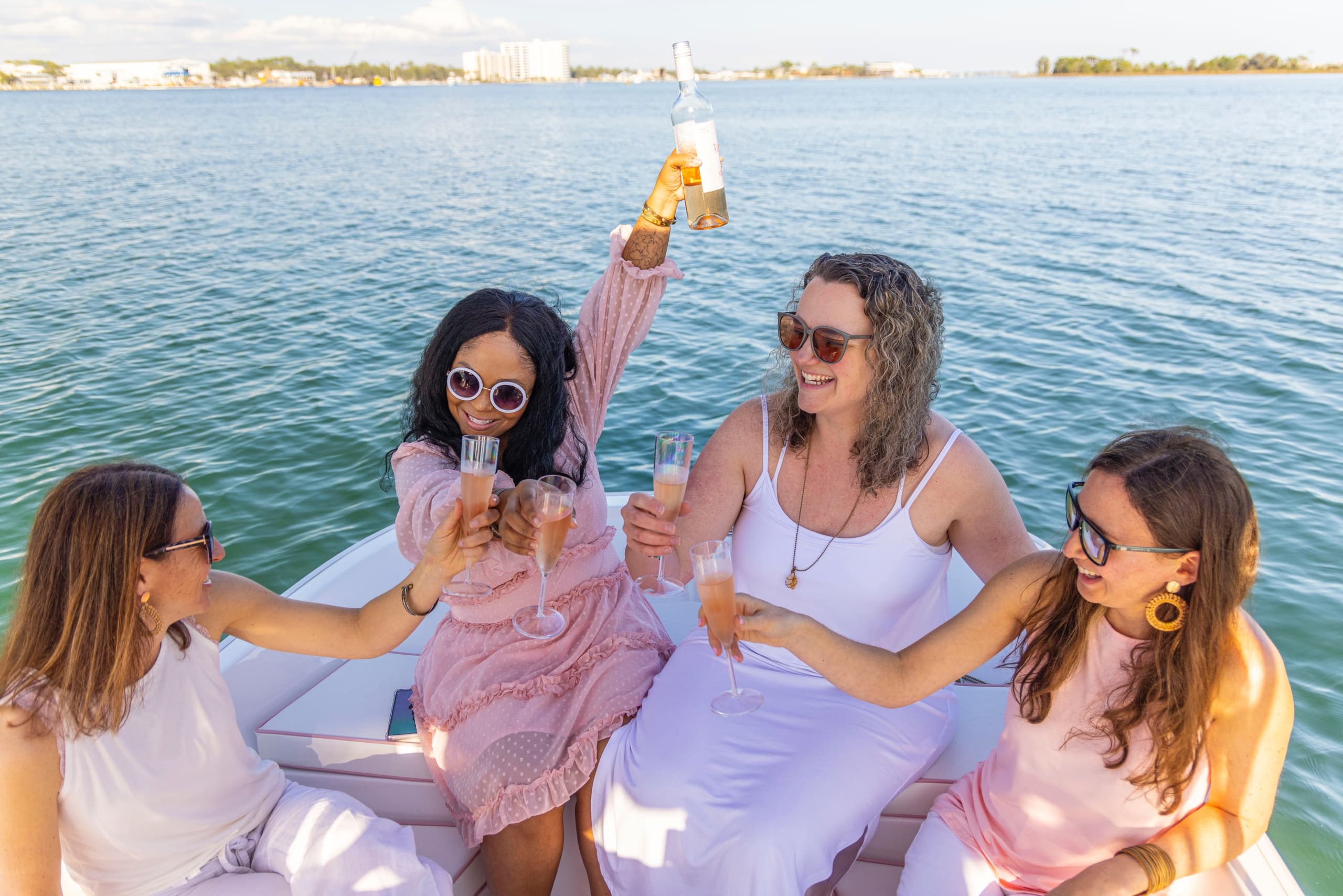 Friends toasting aboard leisure cruise on sunny bay
