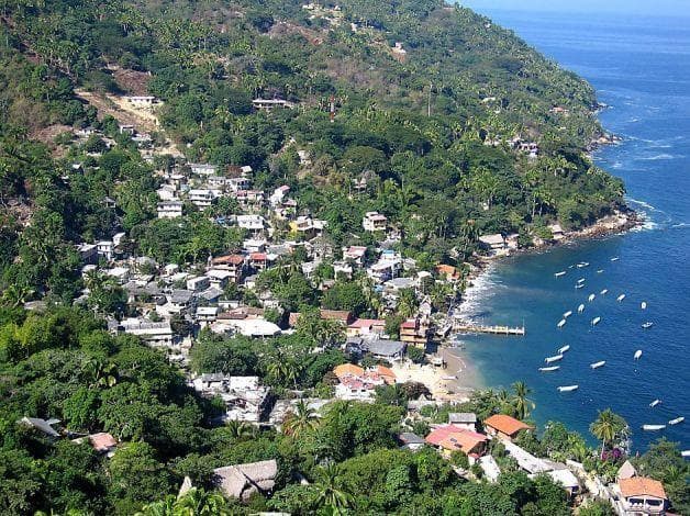 Aerial view of coastal village and bay with boats in Vallarta