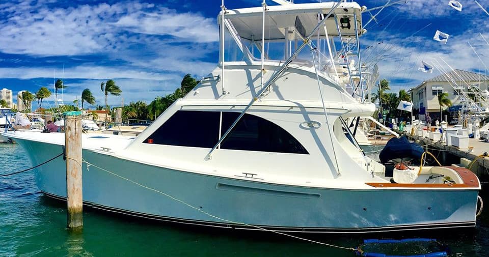 Charter fishing boat docked in marina, ready for offshore fishing trip