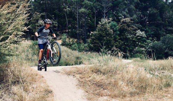 Mountain biker riding forest trail at high speed