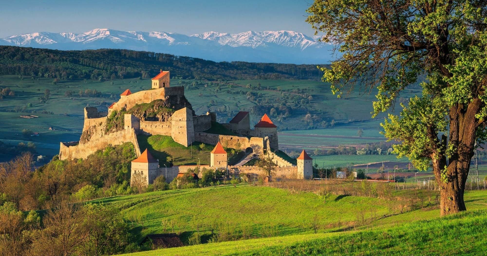 Medieval hilltop fortress ruins offering dramatic mountain views