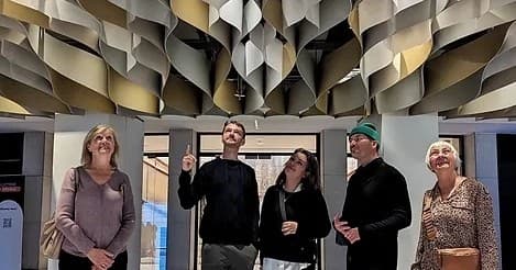 Visitors admiring modern ceiling art installation inside Montreal museum