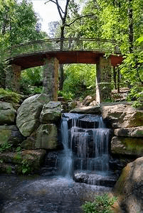 Woodland footbridge over cascading waterfall at Caddo River