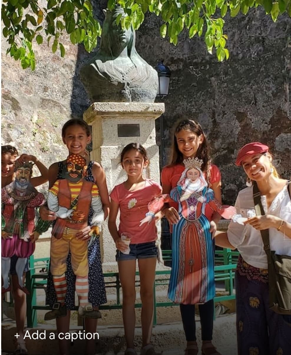 Local cultural puppet performance with children in historic town square