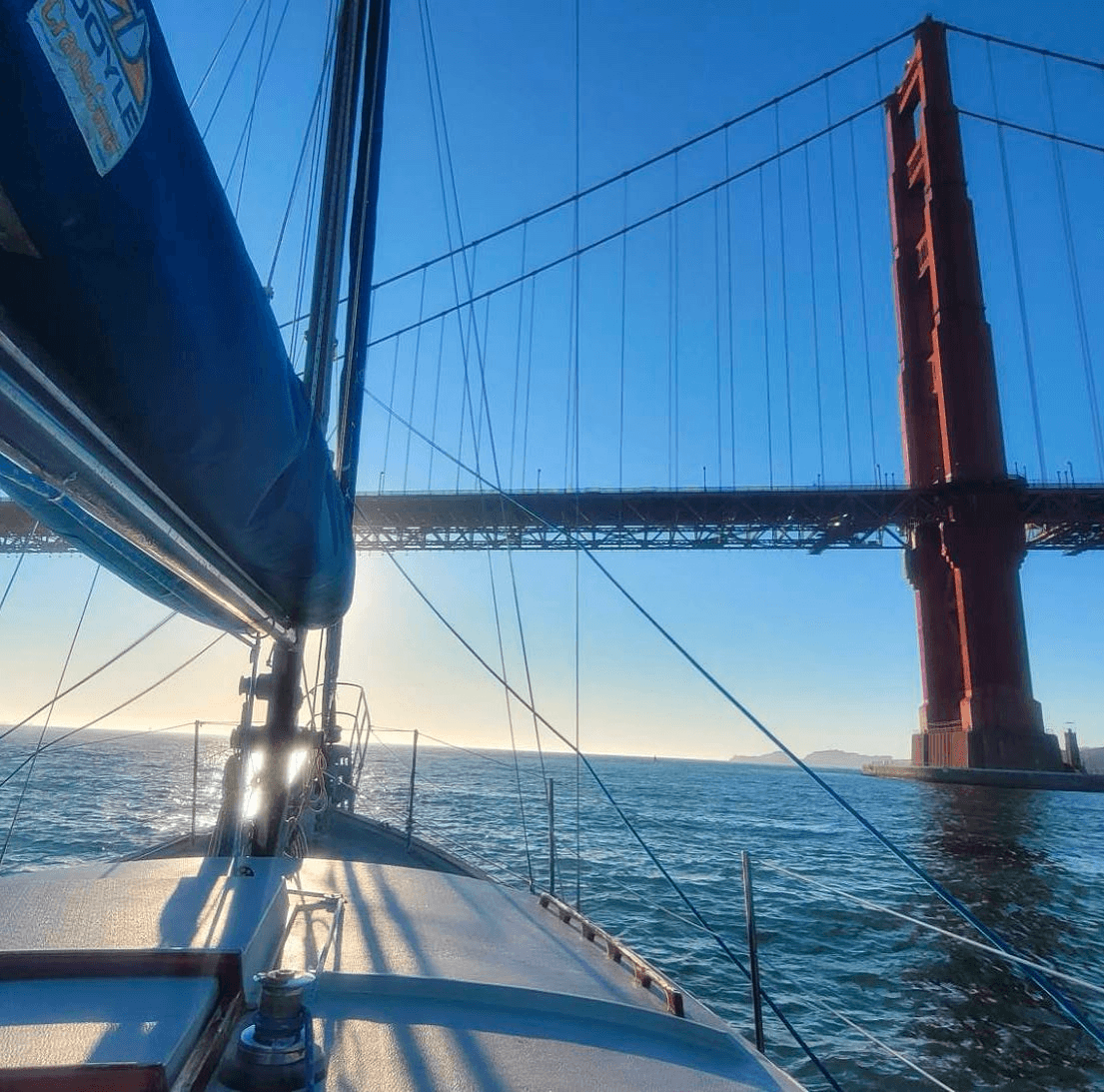 Sailboat cruising under Golden Gate Bridge in San Francisco Bay