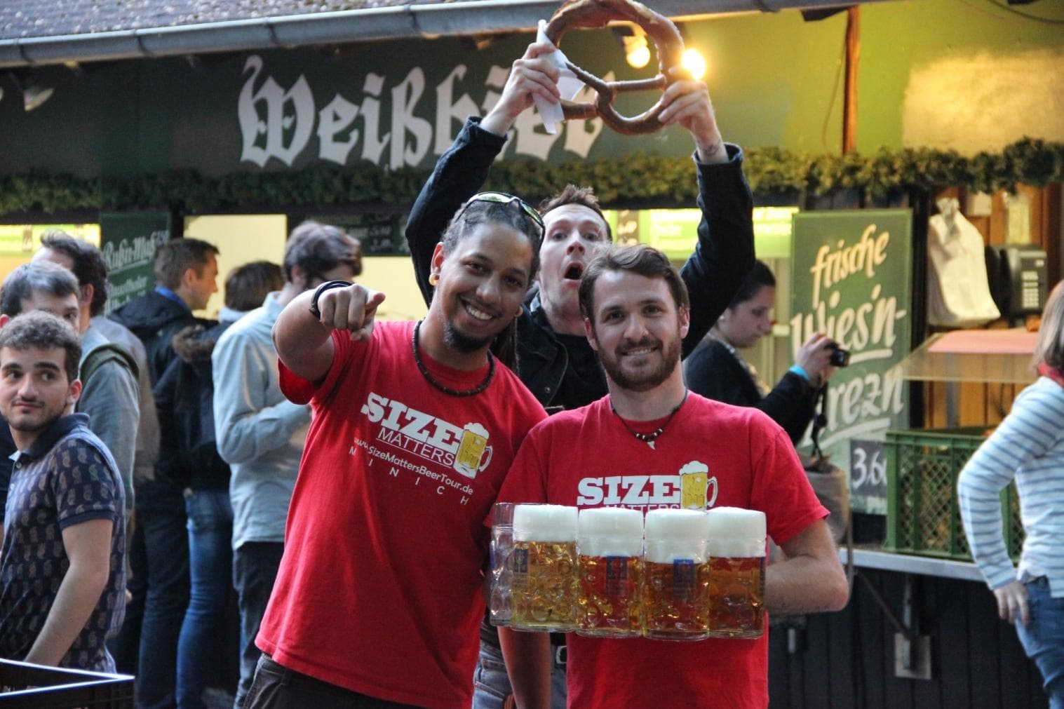 Servers carrying large beer trays at outdoor Munich beer festival