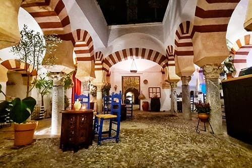 Historic mosque arches interior courtyard in Cordoba with seating