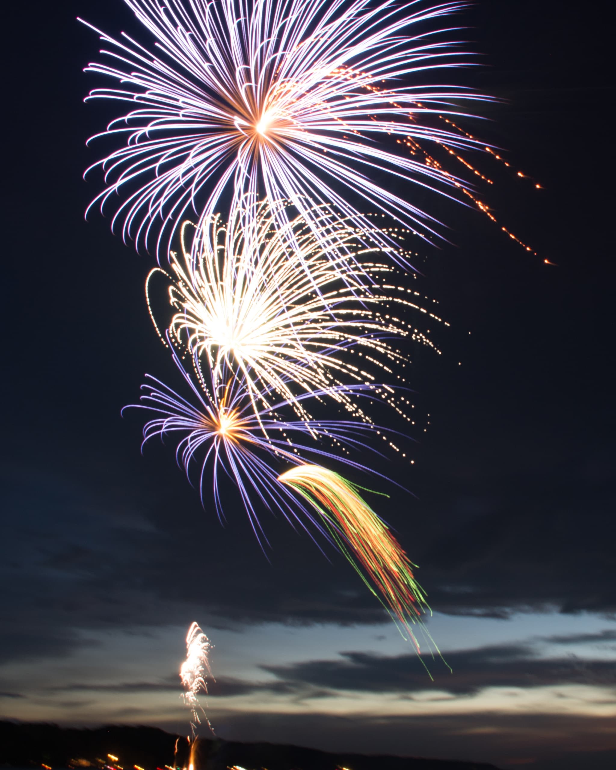 Fireworks celebration over evening harbor during boat cruise