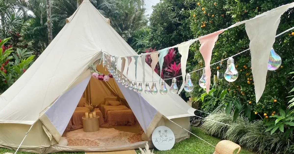 Boho bell tent with bunting in tropical garden camp setup