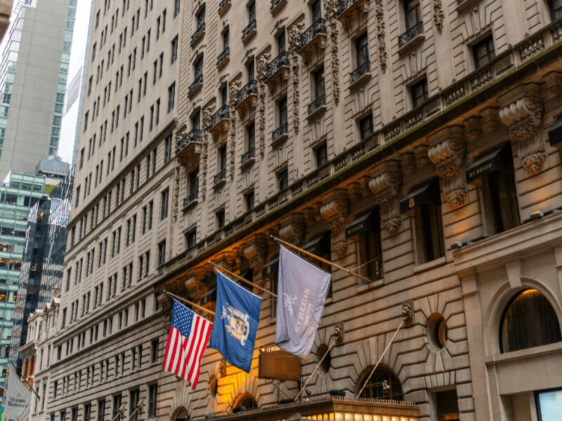 Ornate Fifth Avenue hotel facade with flags, NYC city streetscape