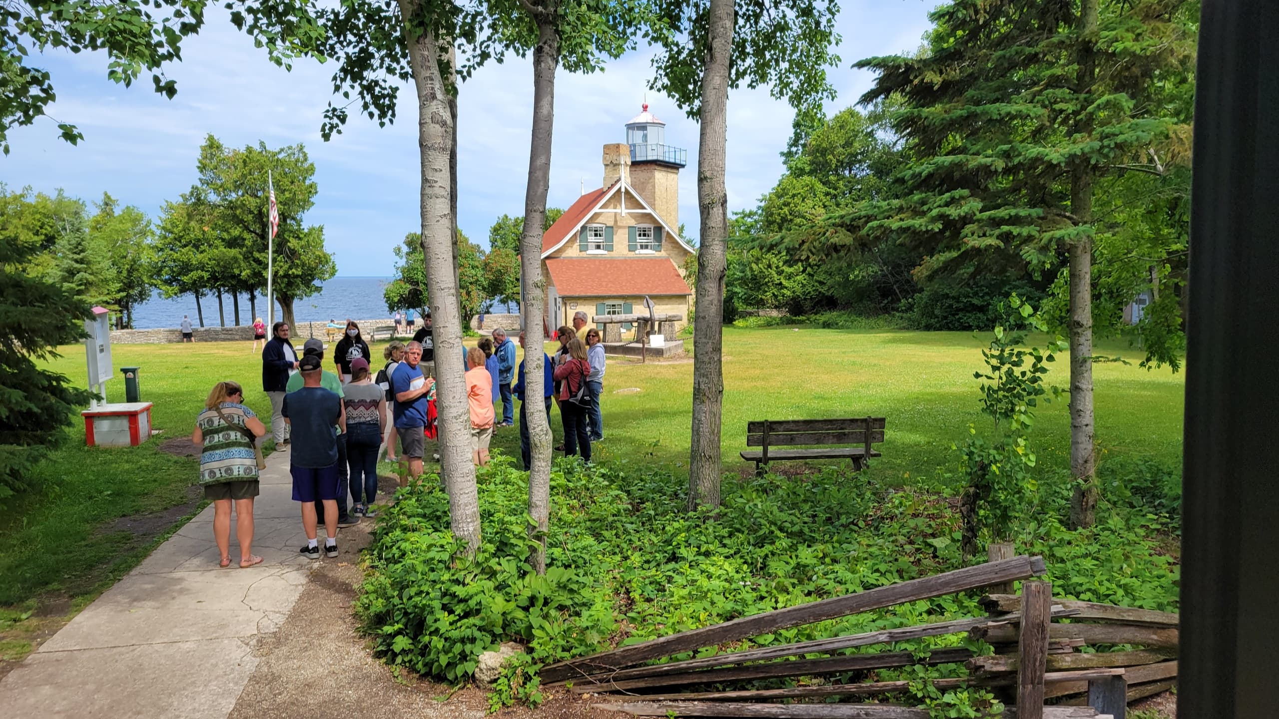 Hikers walking toward historic Door County park and lighthouse