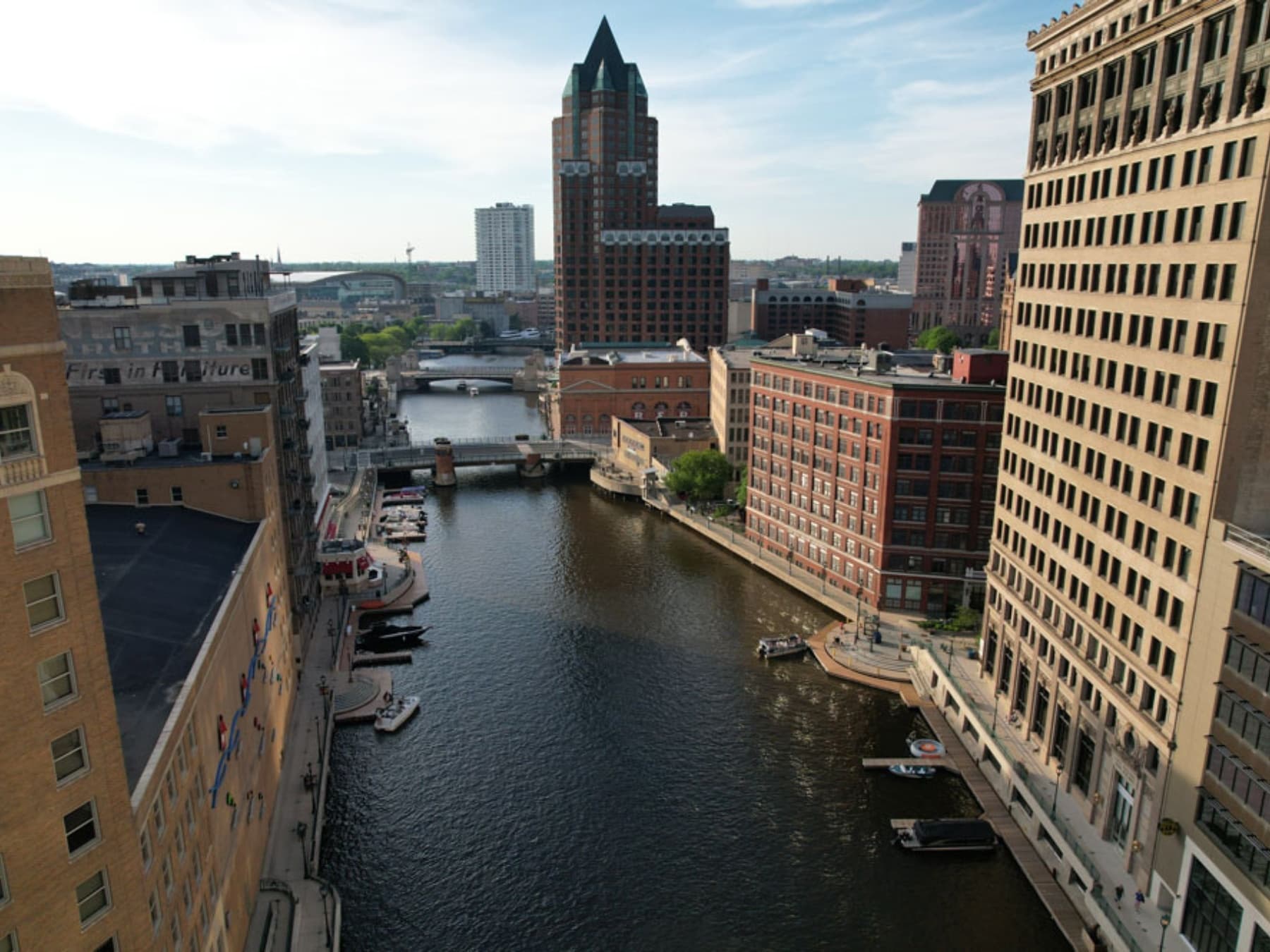 Urban river walk and canal in Milwaukee, aerial downtown view