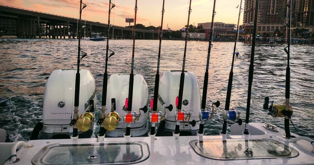 Sunset deep-sea fishing rods and outboard motors on harbor deck
