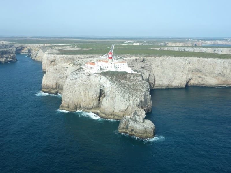 Lighthouse perched on dramatic sea cliffs on Portuguese coast