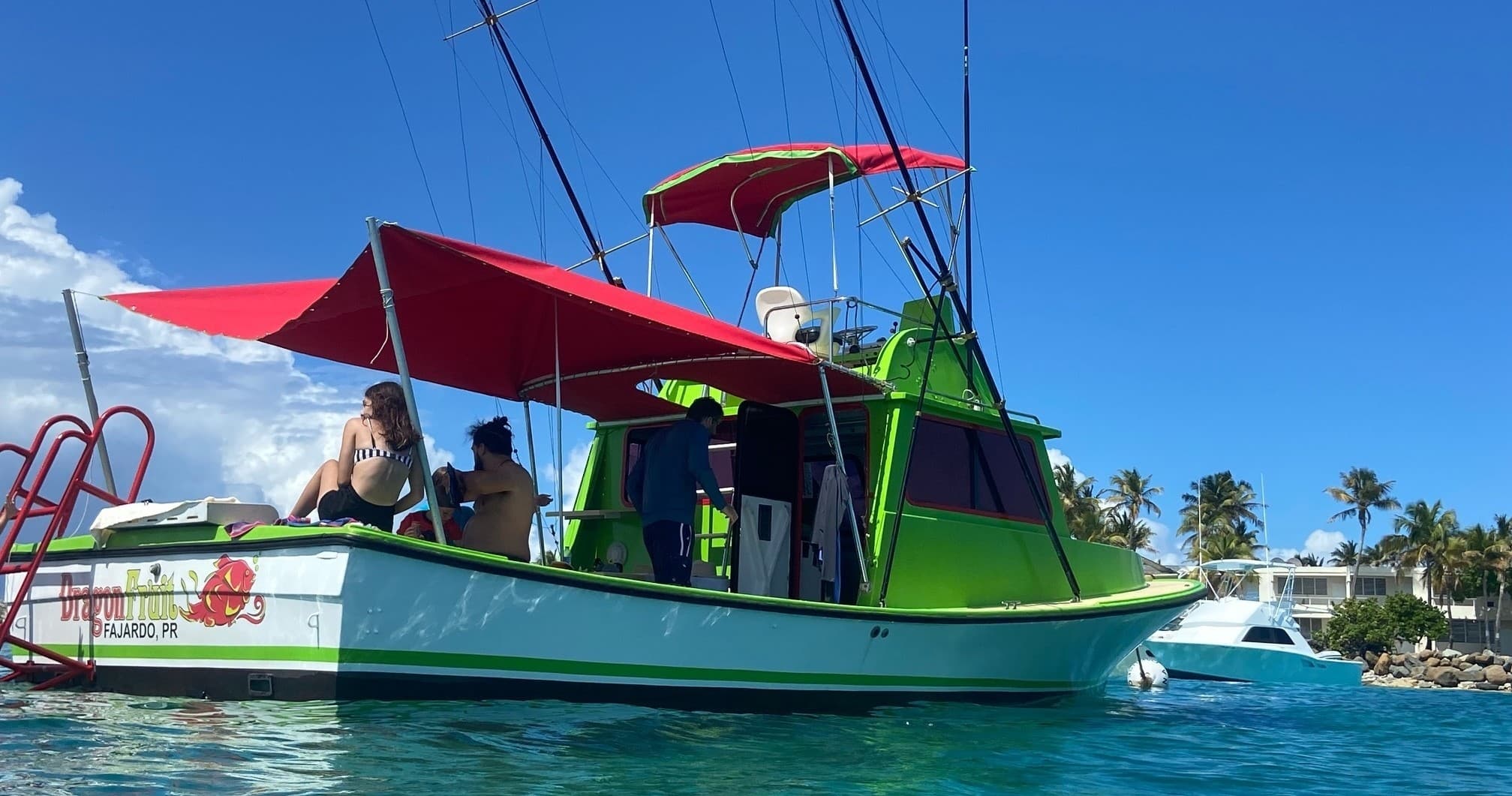 Colorful charter boat anchored in turquoise tropical waters