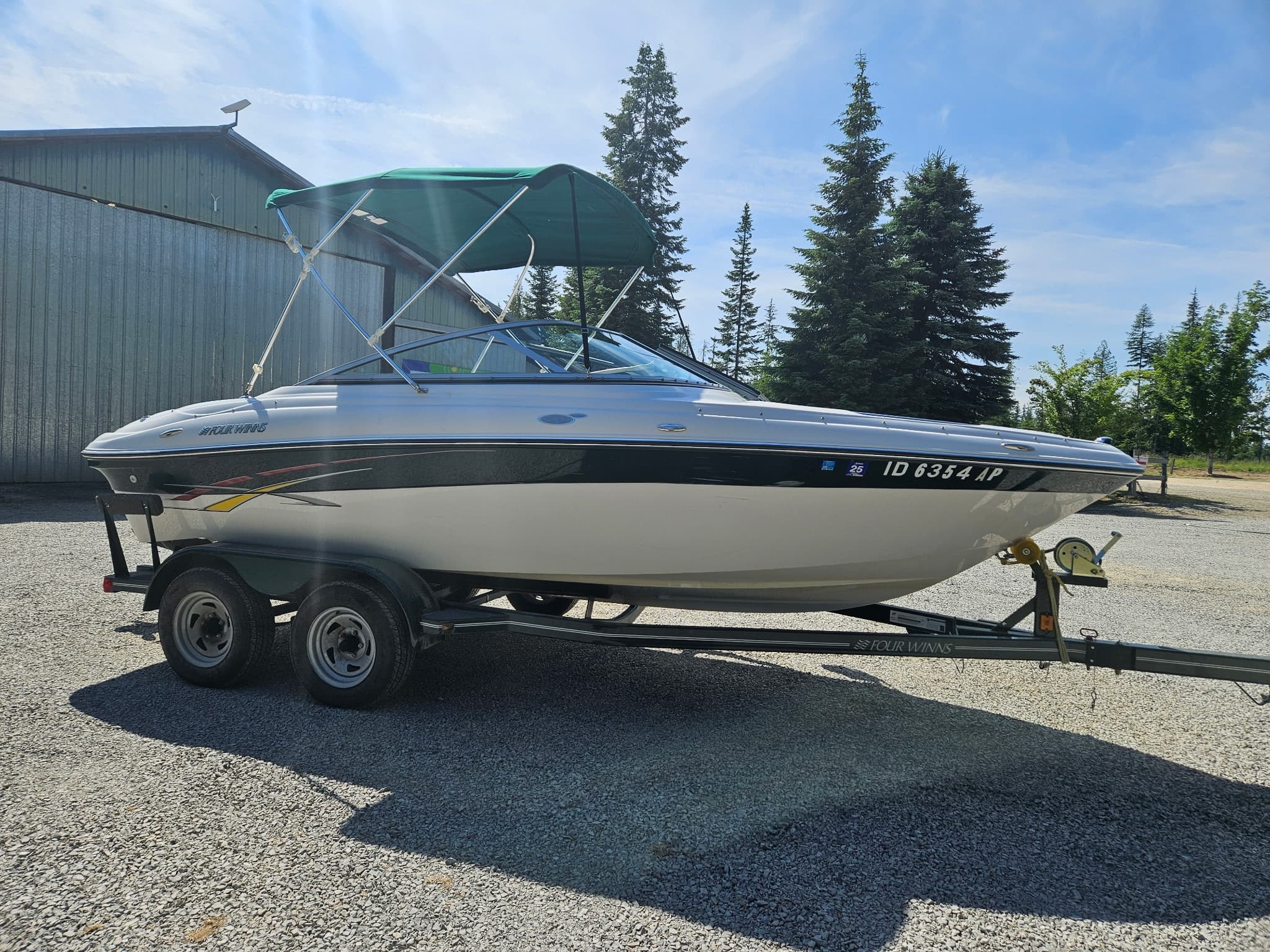 Recreational motorboat on trailer at lakeside storage ready for boating