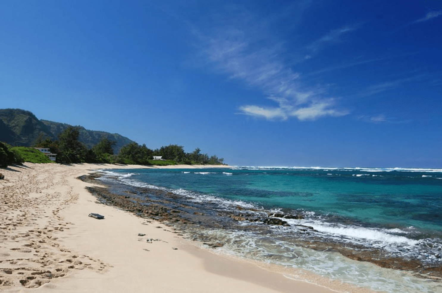 Sandy beach shoreline on Oahu coast, swimming and snorkeling spot