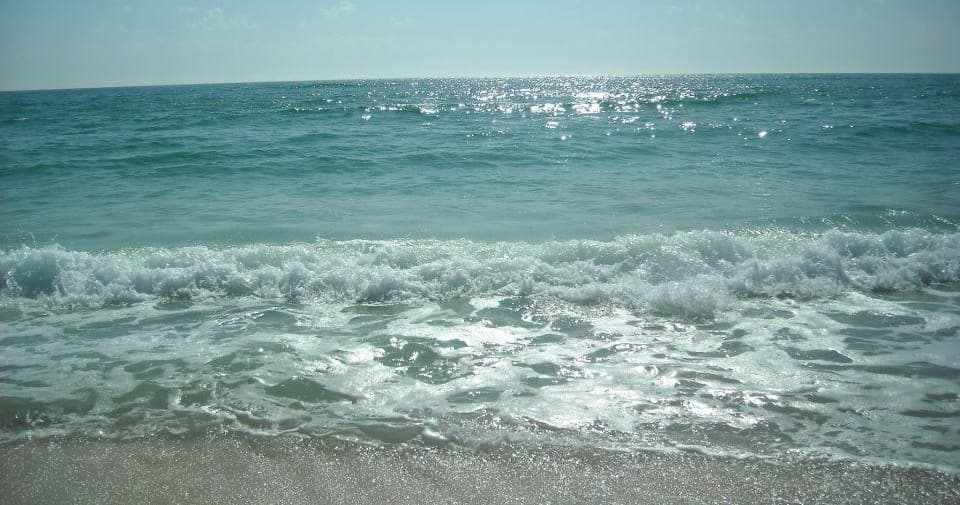 Sandy beach waves lapping shore on Panama City Beach coast