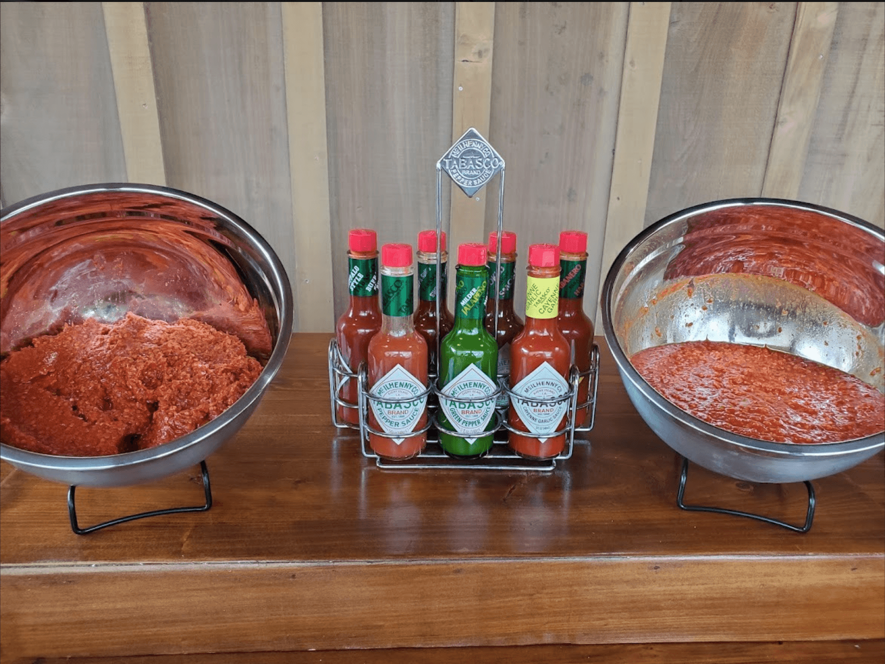 Condiment station with Tabasco bottles and pepper mash bowls indoors