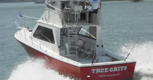 Center console charter boat slicing surf on coastal fishing trip