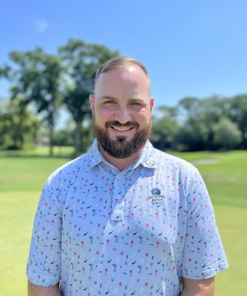 Bearded golf staff portrait on sunny fairway at Palmetto Dunes