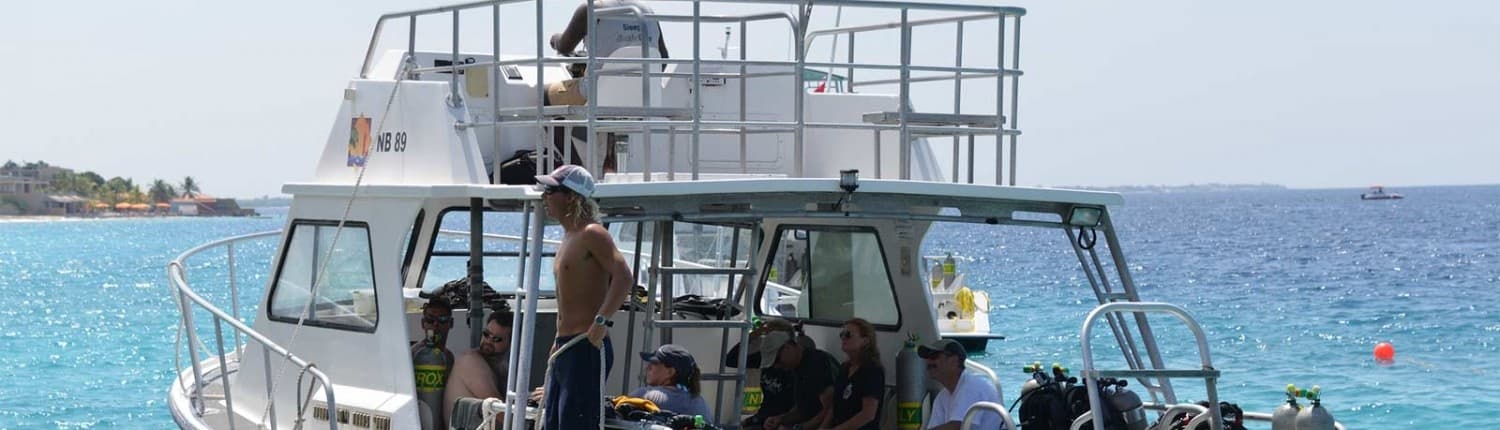 Diving charter boat anchored offshore preparing divers for open water