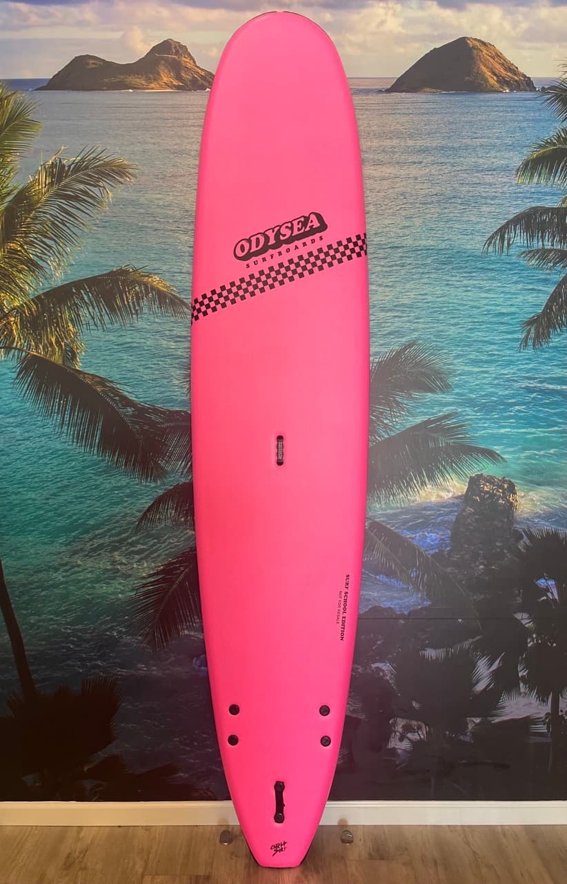 Hot pink longboard surfboard for surfing staged with tropical beach backdrop