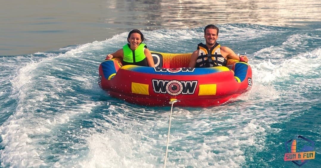 Towed inflatable tubing ride on Persian Gulf waters, thrilling family fun