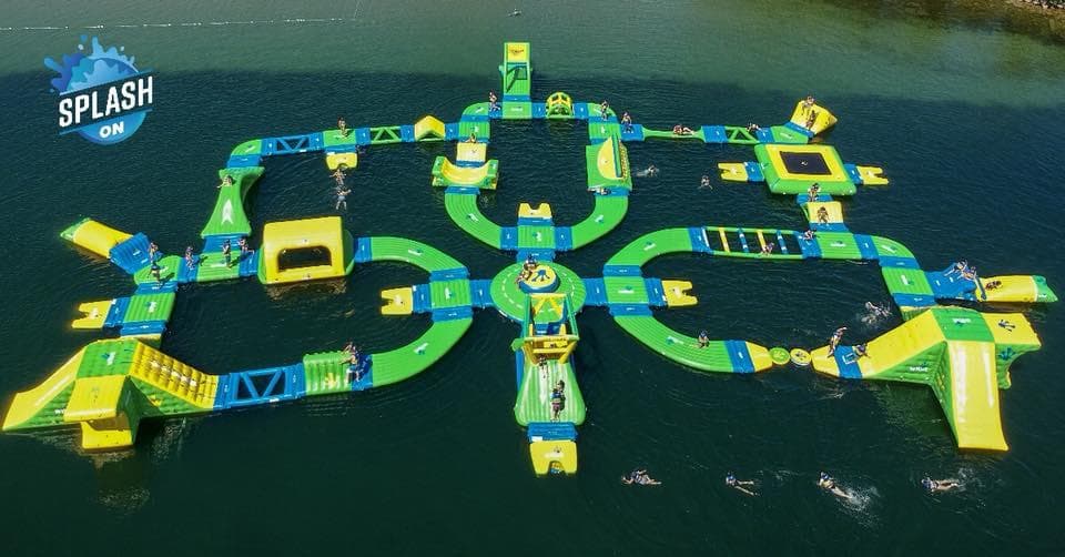 Symmetrical aerial view of floating obstacle course on lake