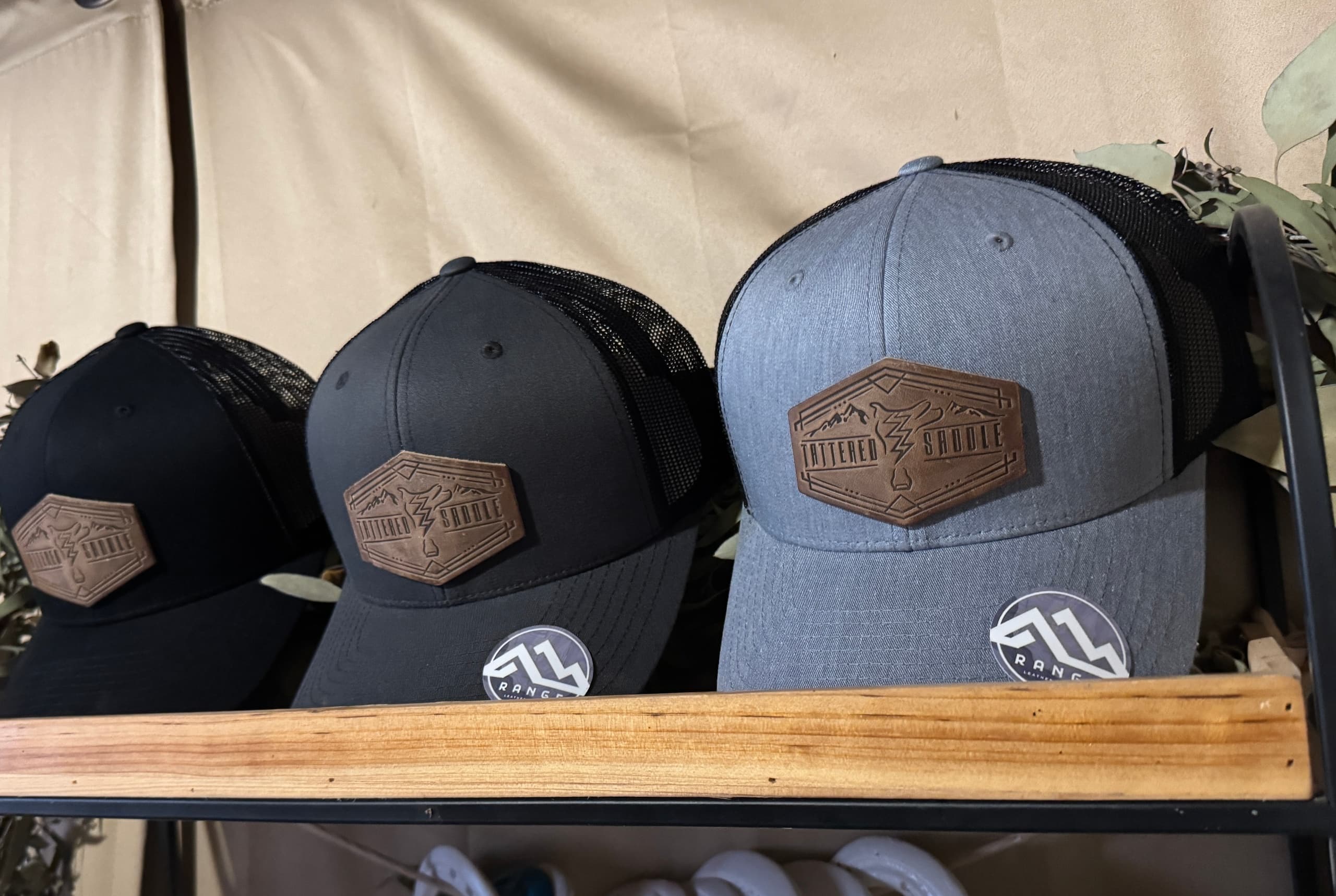 Branded trucker hats on display at outdoor gear booth