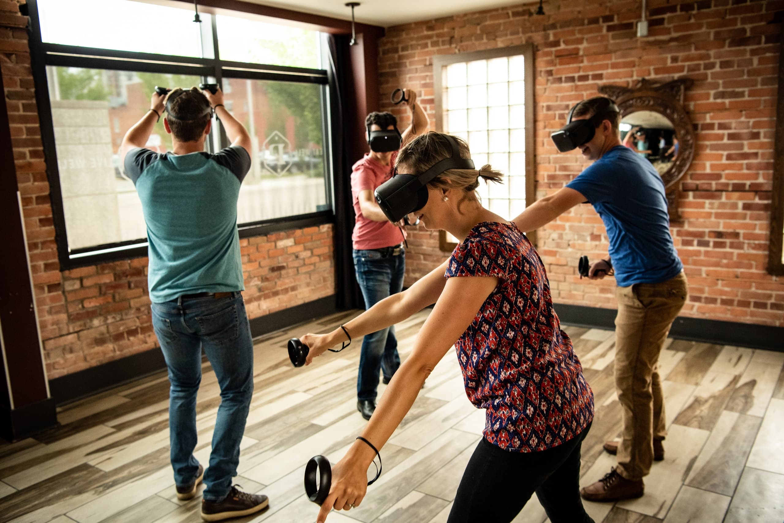 Group VR gaming session in brick loft-style indoor VR arena