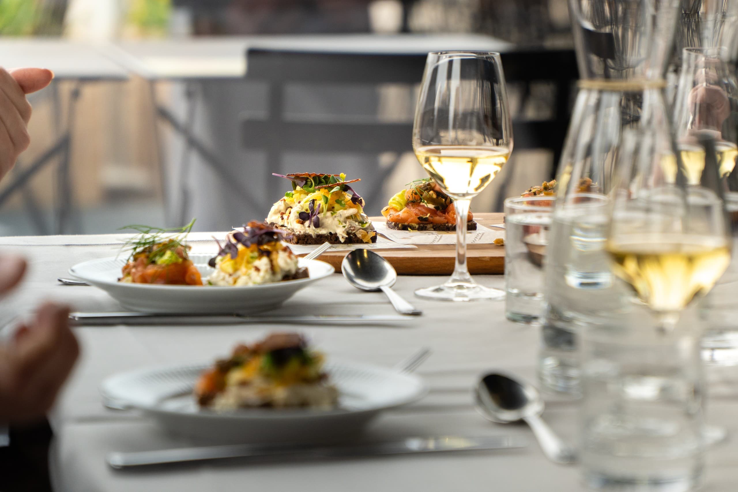 Outdoor gourmet tasting plates and wine on Copenhagen waterfront