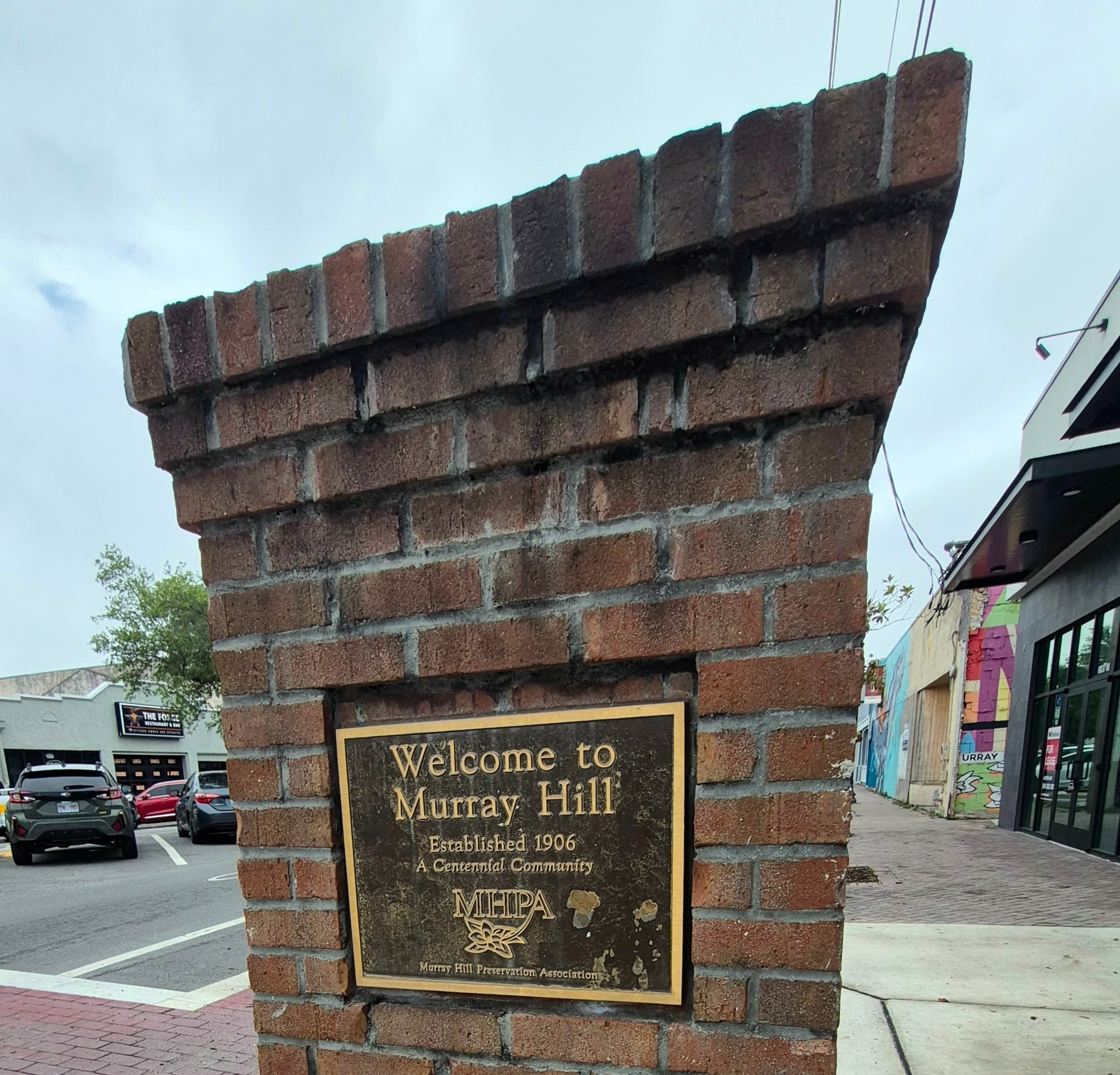 Welcome to Murray Hill historic brick entry sign on sidewalk