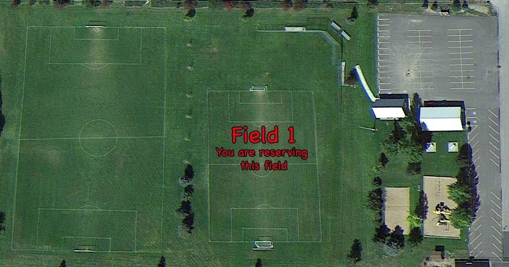 Aerial Field 1 sports complex and parking, expansive grassy pitch